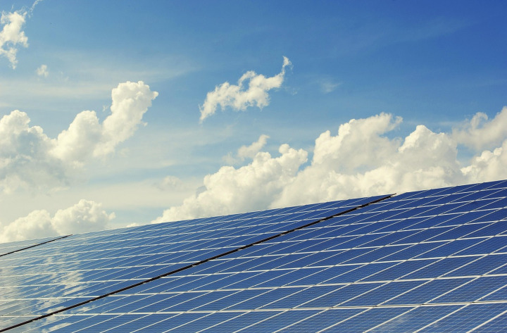 technician cleaning solar panels